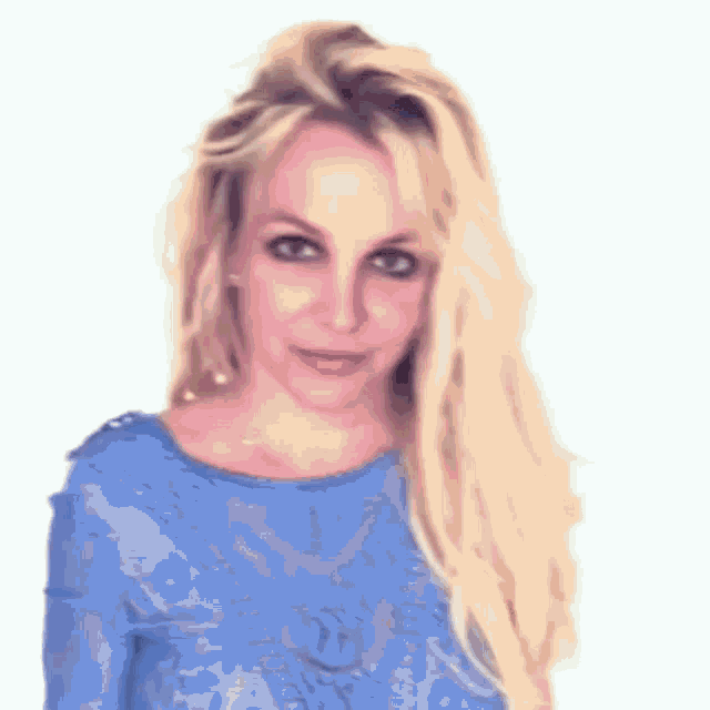 britney spears is wearing a blue shirt and making a funny face