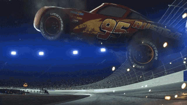 a race car is going down a track with flames coming out of the back