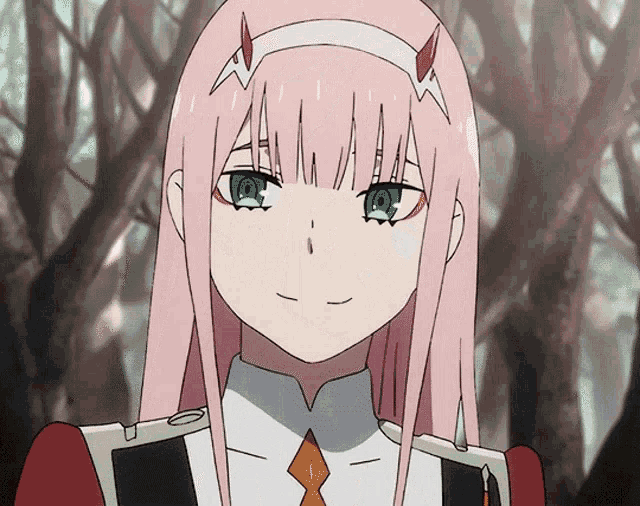 a girl with pink hair and green eyes is smiling