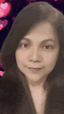 a woman 's face is shown with hearts in the background