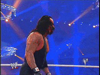 a man in a black tank top with a w on the back