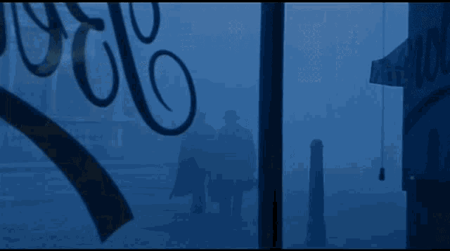 a foggy street with a sign that says ' ' ' ' ' ' ' ' ' on it