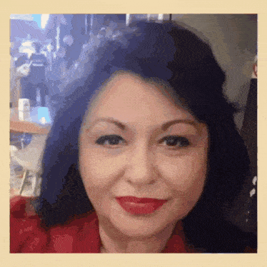 a woman with blue hair and red lipstick is smiling