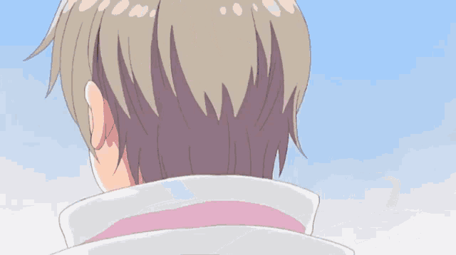 the back of a person 's head with a blue sky behind them