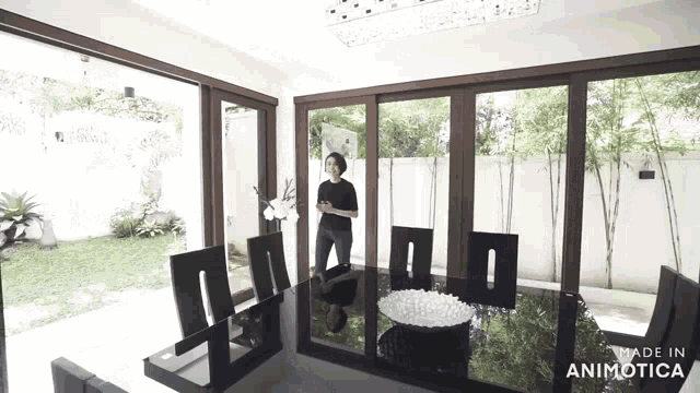 a woman is standing in a dining room with a table and chairs made in animotica