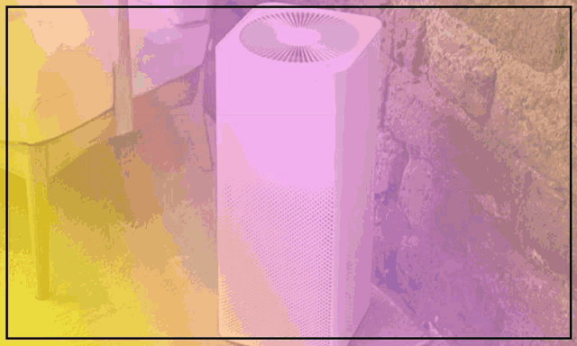 a home air purifier is advertised on a pink background