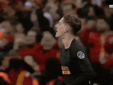 a soccer player wearing a black shirt with the number 2 on it