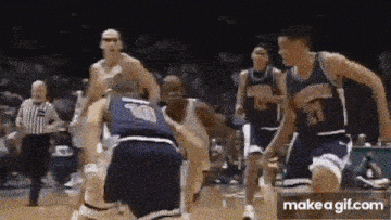 a group of basketball players are playing a game of basketball .