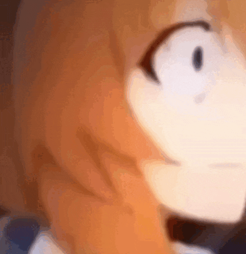 a close up of a cartoon character 's face with a blurred background