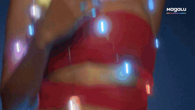 a woman in a red bra is surrounded by christmas lights and the word magalu is on the bottom right