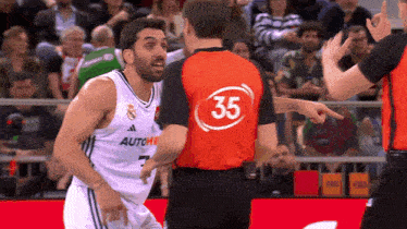 a basketball player with the number 35 on his back talks to another player