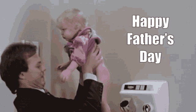 a man is holding a baby in his arms with the words happy father 's day written above him