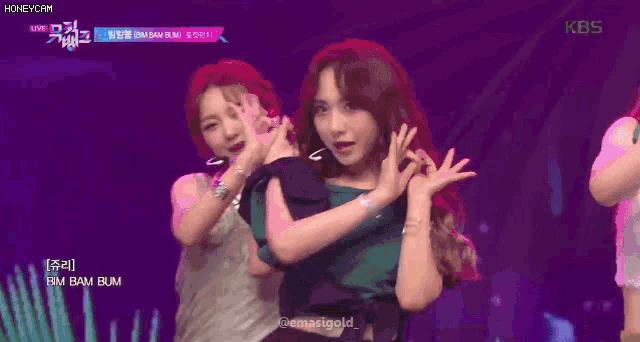 a girl in a green shirt is dancing on stage