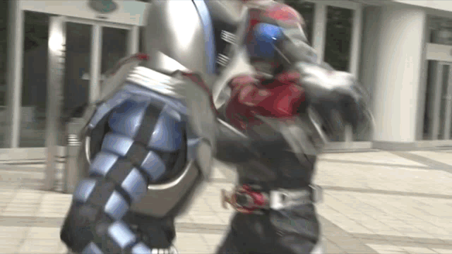 a man in a robot costume is fighting another man in a robot costume .