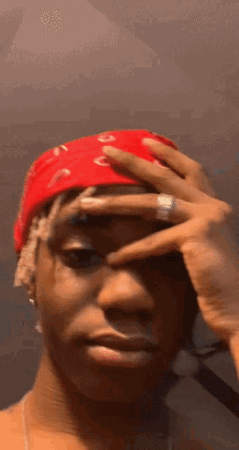 a man wearing a red bandana on his head