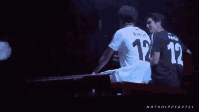 a man wearing a white jersey with the number 12 on it