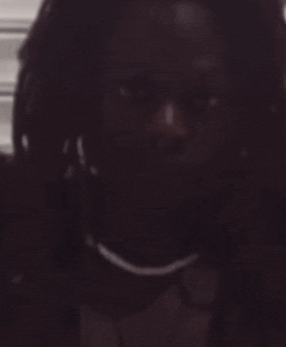a man with dreadlocks is looking at the camera
