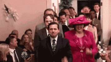 a man in a suit and tie is walking down the aisle of a wedding ceremony .