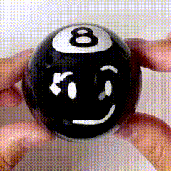 a person is holding a pool ball with a smiley face on it