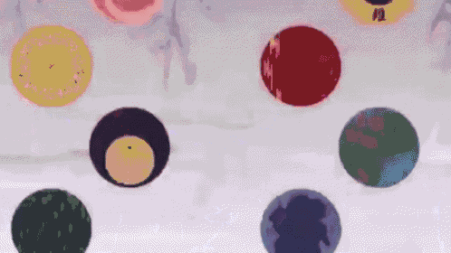 a bunch of circles of different colors are floating in the air