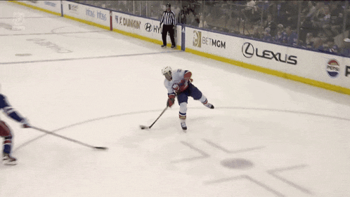 a hockey game is being played on a ice rink with a lexus advertisement in the background