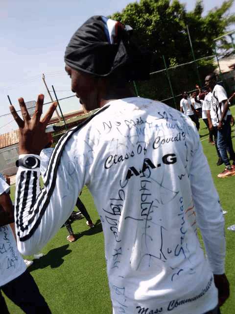 a man wearing a white shirt that says class of council