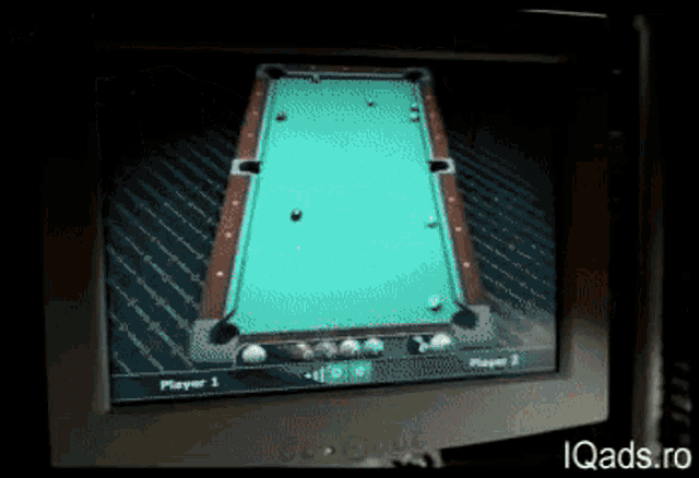 a computer monitor shows a pool game with player 1 and player 2 on the screen
