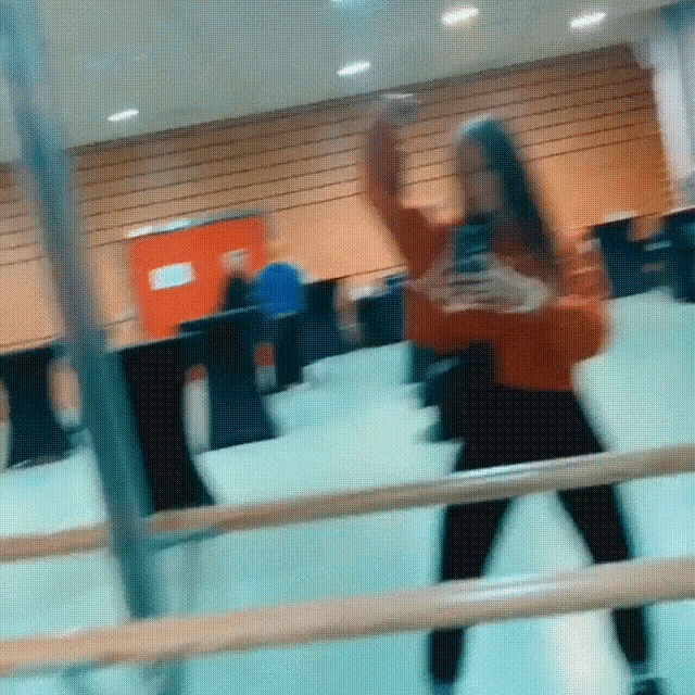 a woman taking a picture of herself in a mirror