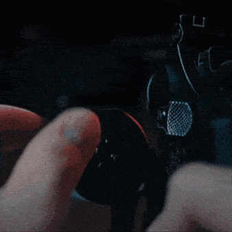 a man in a suit and tie is holding a gun up to his head
