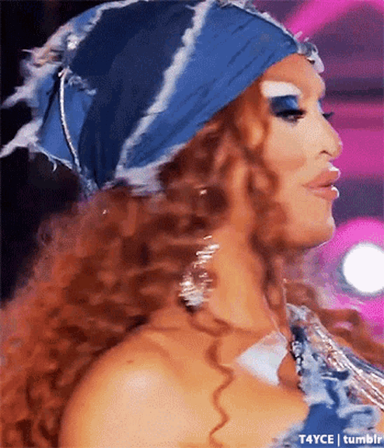 a woman with red hair is wearing a blue headband