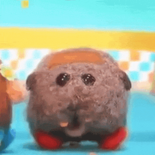 a stuffed animal is standing on a blue surface with a yellow and blue background .