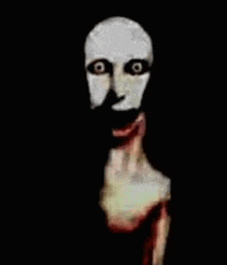 a close up of a scary face with blood coming out of it 's mouth .