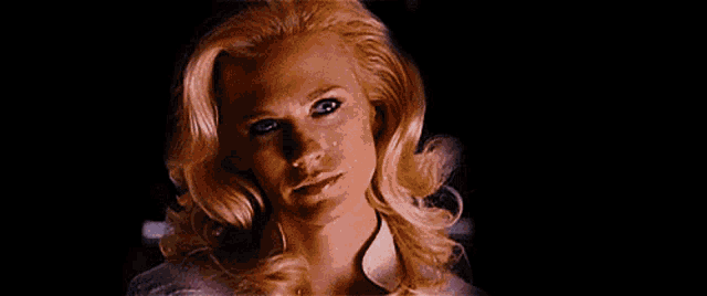 a close up of a woman with ice on her face and hair .