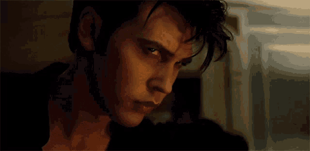 a close up of a man 's face with his eyes looking at the camera