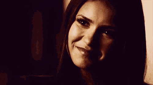 a close up of a woman smiling with her eyes closed .