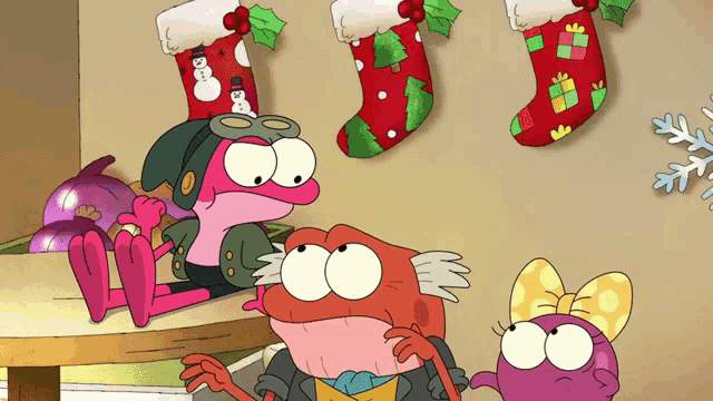 three cartoon characters are looking at christmas stockings hanging on the wall