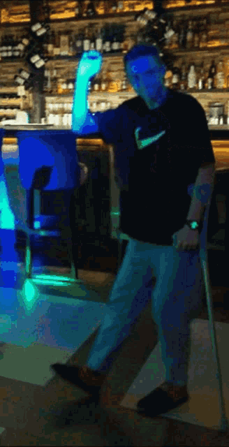 a man with crutches and a nike shirt on
