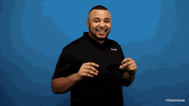 a man is smiling in front of a blue background with the words you got it