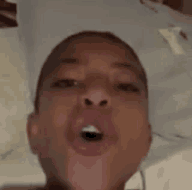 a close up of a person 's face with their mouth open and teeth showing .
