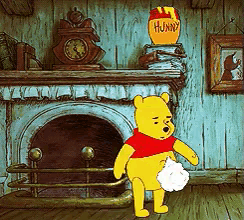 winnie the pooh is standing in front of a fireplace with a jar of honey in the background