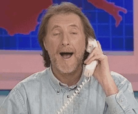 a man talking on a phone with his mouth open