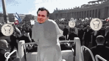 a man in a white robe is standing in a crowd of people