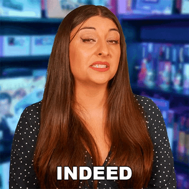 a woman with long hair says indeed in a polka dot top