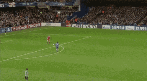a soccer field with a banner that says ' born is the king ' on it