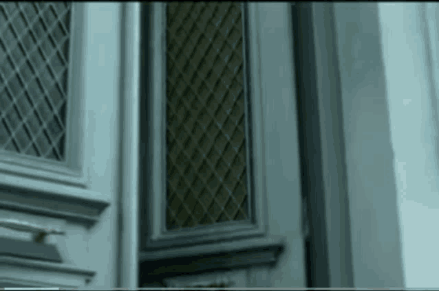 a close up of a door with a checkered pattern on it