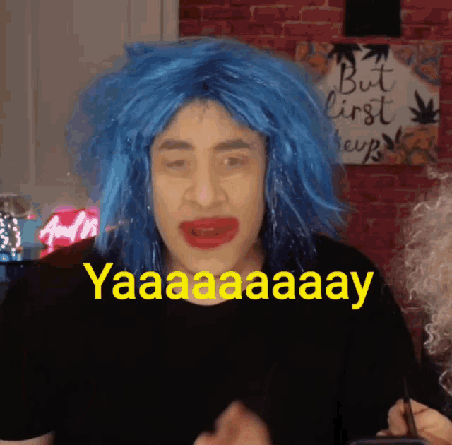 a man wearing a blue wig and red lips says yaaaaaaay