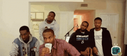 a group of men including one wearing a shirt that says born in a foreign land