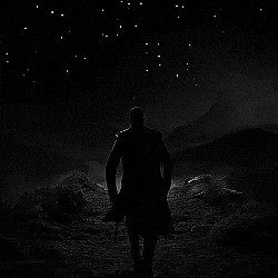 a black and white photo of a man walking on a path