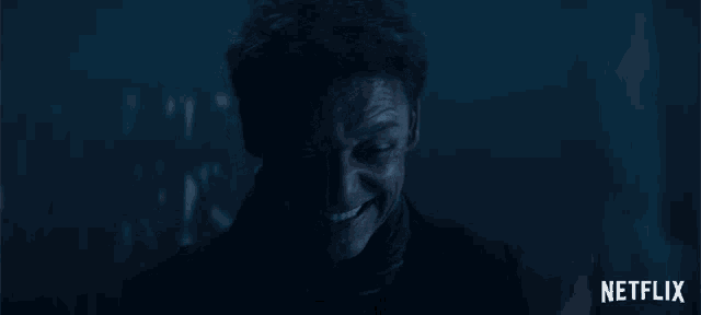 a man in a dark room with a netflix logo on the bottom