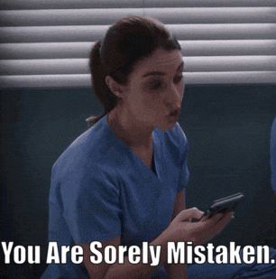 a woman in scrubs is looking at a cell phone with the words you are sorely mistaken below her